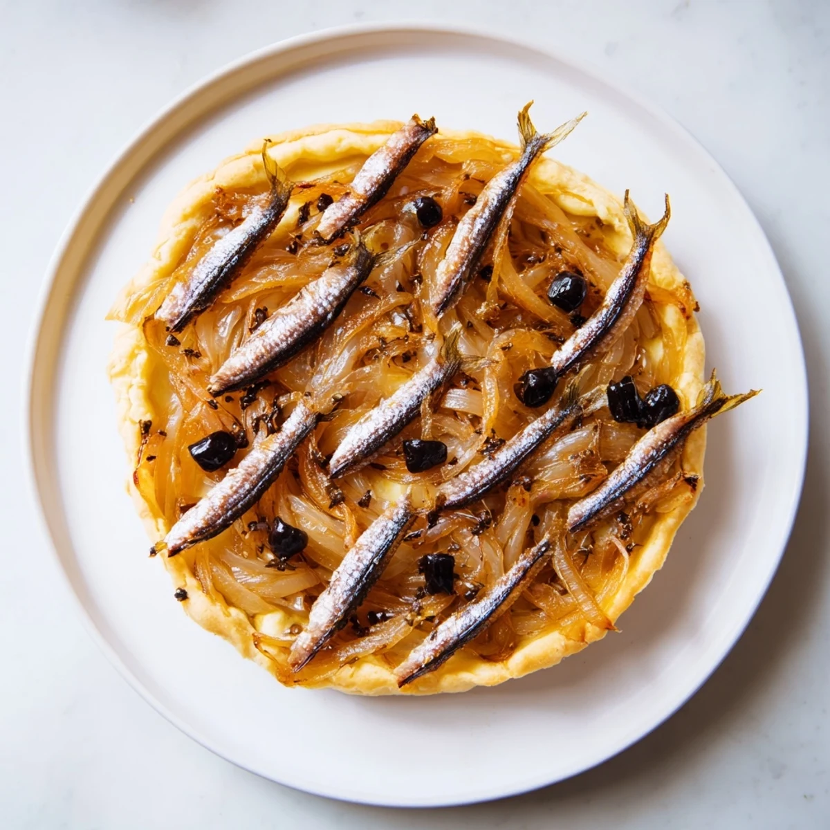 Warm, fragrant Classic Onion Pissaladière, freshly baked, with glistening caramelized onions and a flaky puff pastry.