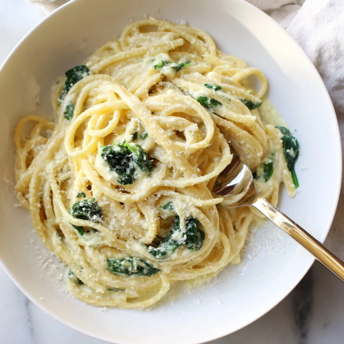 This decadent Creamy Greek Yogurt Spinach Alfredo Pasta dish uses healthy Greek yogurt for a satisfying meal.