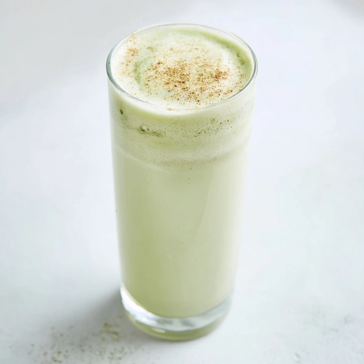 Matcha Eggnog Collagen Breakfast Smoothie swirled in a glass, ready for a nutritious, flavorful breakfast.