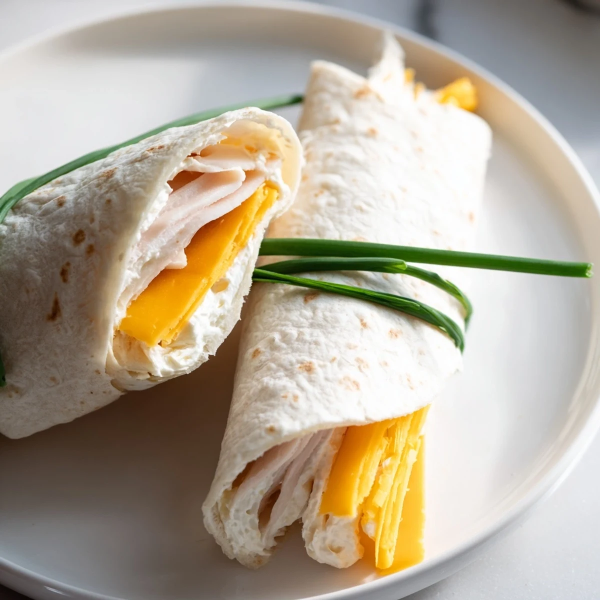 These Graduation Cap Diploma Snack Wraps feature rolled tortilla diplomas tied with chives and chocolate truffle caps.