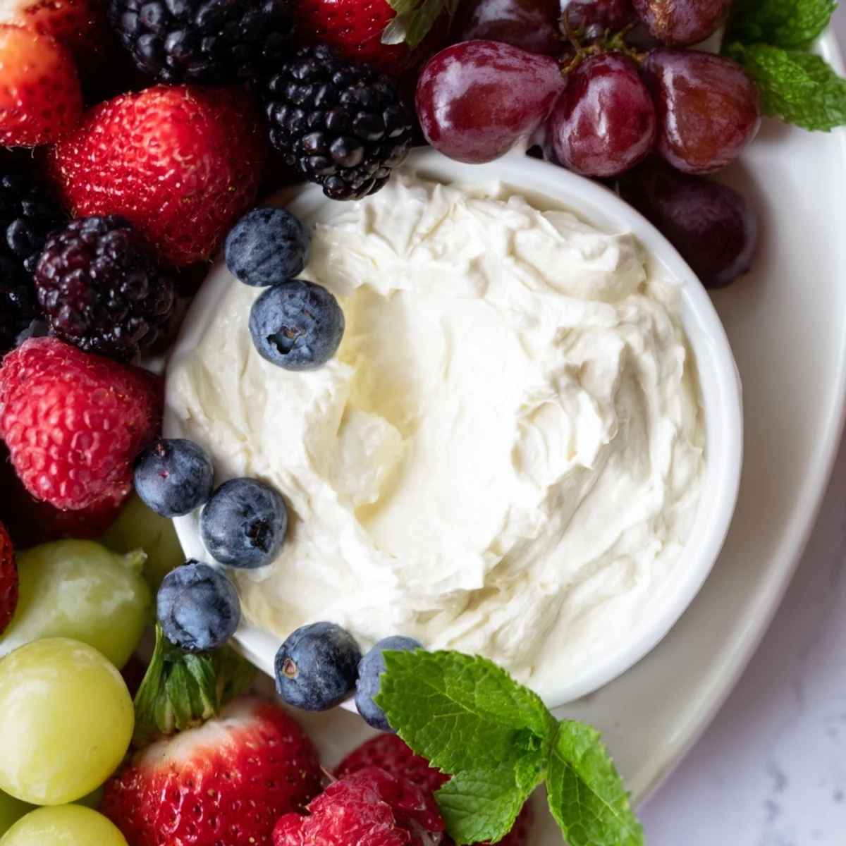 Mistletoe Kiss Berry Dip Board overflows with a vibrant selection of fresh berries and a creamy dip, perfect for sharing.