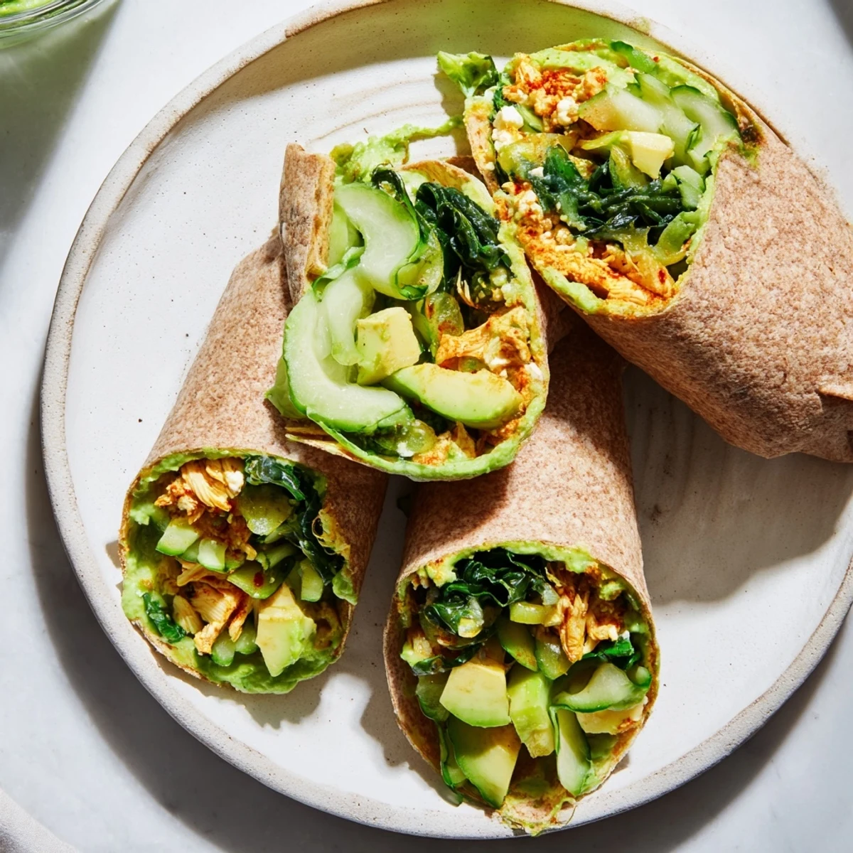 Vibrant Green Goddess Wellness Wrap with juicy chicken, crunchy veggies, drizzled with creamy dressing, ready to eat.