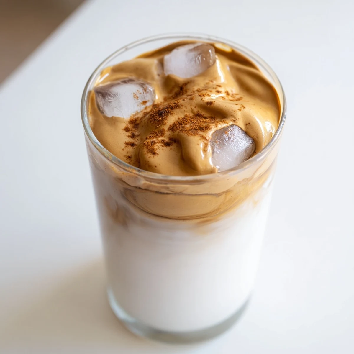 Creamy brown sugar Dalgona latte topped with a swirl of whipped coffee, is a perfect café style treat.