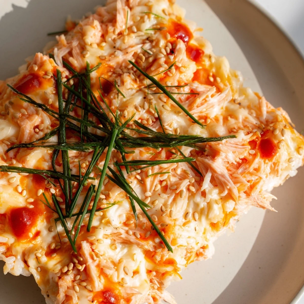 Golden, bubbly Creamy Salmon Sushi Bake, a deconstructed sushi dish with savory salmon and melted cheese.