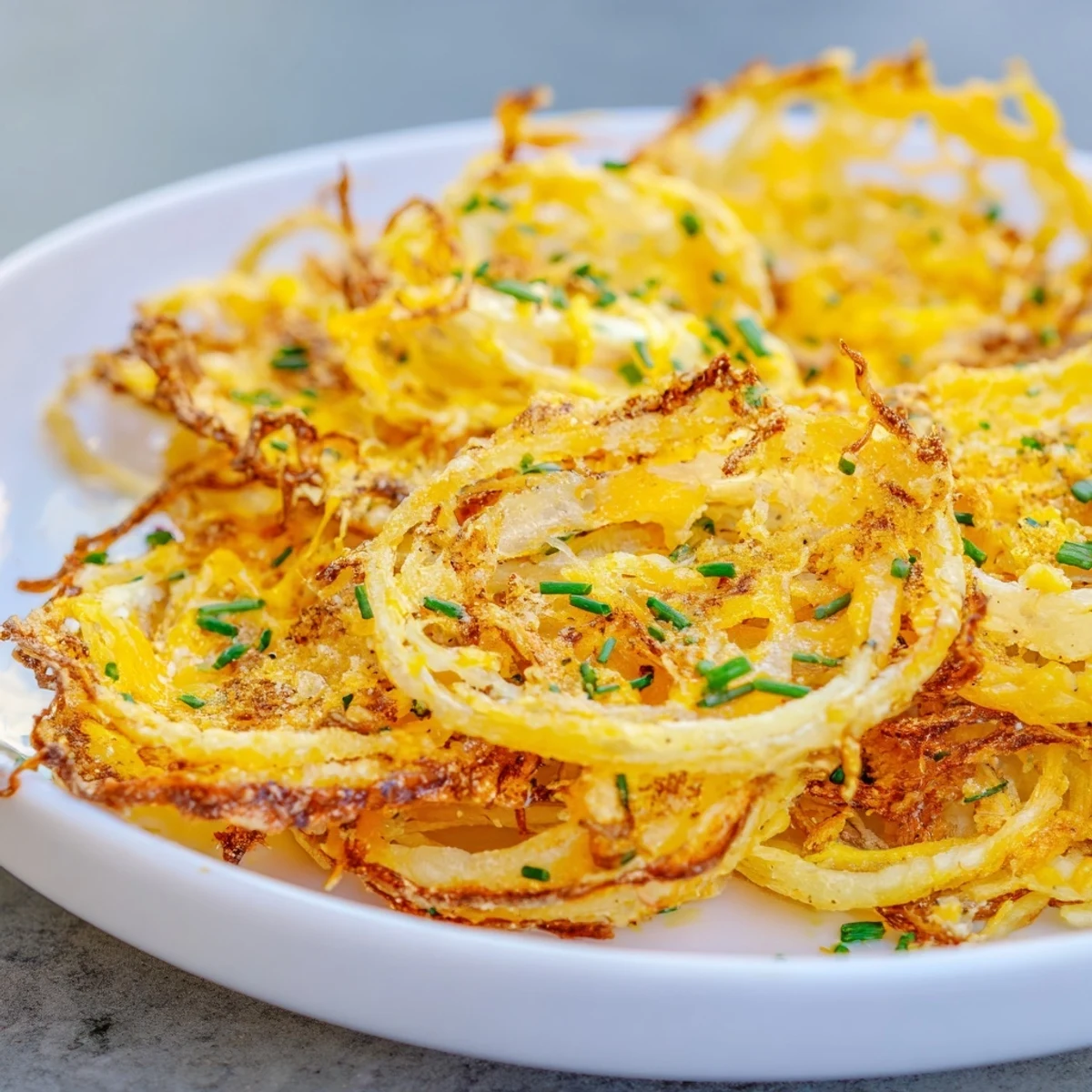 Air fryer's perfect Crispy Onion Cheese Chips: crispy, cheesy, and spiced to perfection for snack time.