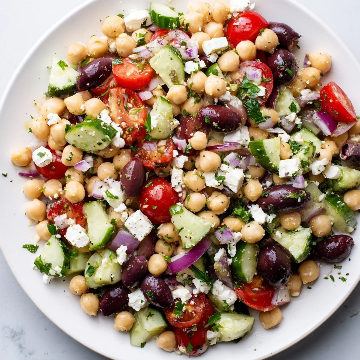Vibrant Mediterranean Chickpea Salad with creamy feta, glistening olives, and a bright lemon dressing.