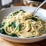 Bright green spinach and velvety sauce coat the Creamy Greek Yogurt Spinach Alfredo Pasta noodles.