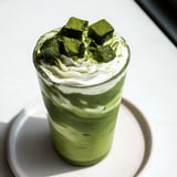 A refreshing close-up of the sugar-free white chocolate candy cane iced matcha with whipped cream and crushed candy canes.