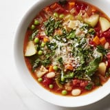 A festive, close-up view of the hearty Veggie-Packed Minestrone Christmas Pasta Pot, garnished with fresh parsley.