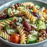 Fresh and flavorful Summer Pasta Salad: Greek Style with Olives and Feta, featuring al dente pasta, vibrant veggies, and tangy red wine vinaigrette.  