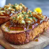 Vibrant yellow dandelion jelly glistens in a mason jar, ready to brighten your breakfast toast or pastries.