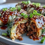 Savory Korean Cabbage Rolls stacked neatly, tender leaves embracing seasoned ground beef.