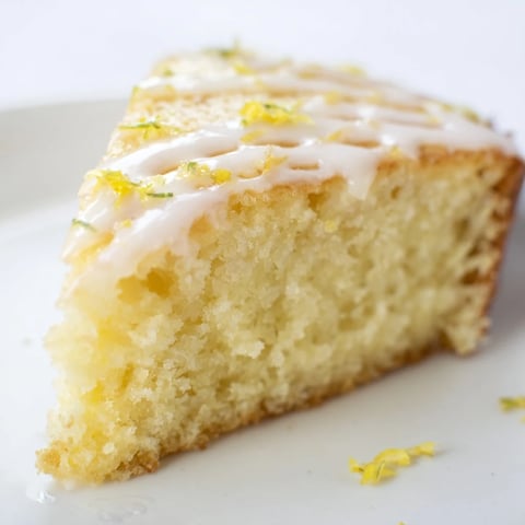 Fluffy lemon yogurt cake, topped with glaze, promises a bright, zesty dessert experience.