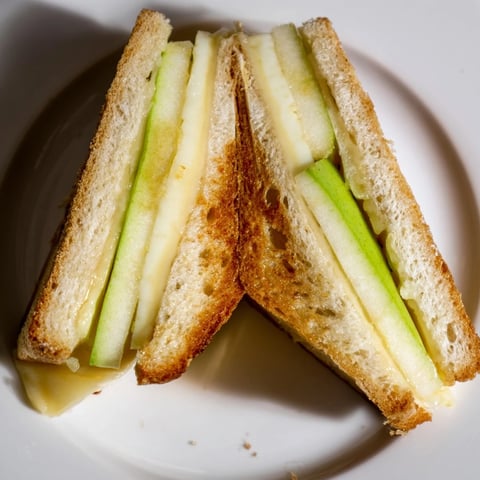 Golden, melted Brie and apple grilled cheese, a warm, comforting sandwich, perfectly crisped.