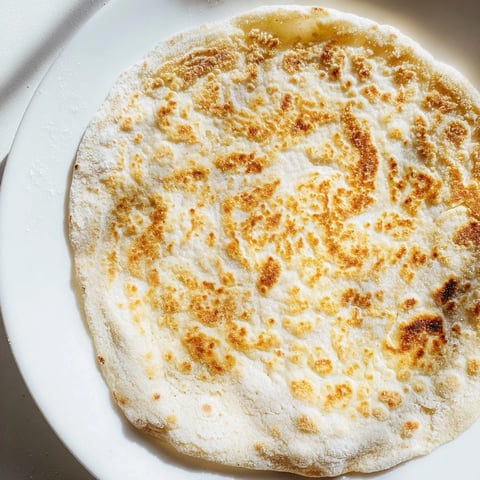 Golden-brown Cottage Cheese Flatbread, pan-fried to perfection, ready to be enjoyed with flavorful dips.