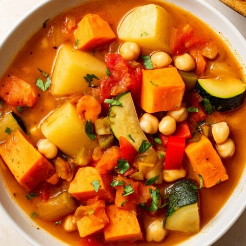 Steaming bowl of Hearty Vegan Sweet Potato Stew, showcasing rich flavors and vibrant vegetables.