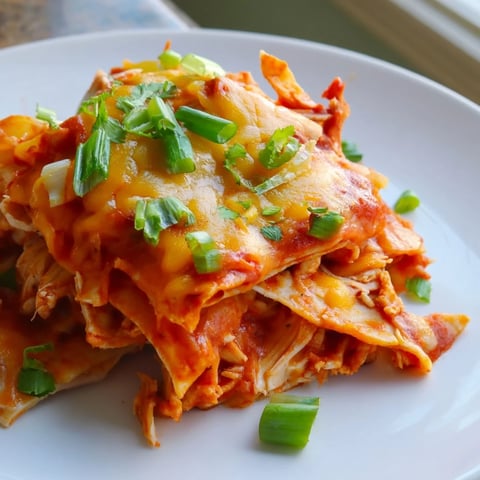 Savory Chicken Enchilada Skillet bubbling with melted cheese, brimming with tender chicken and veggies.