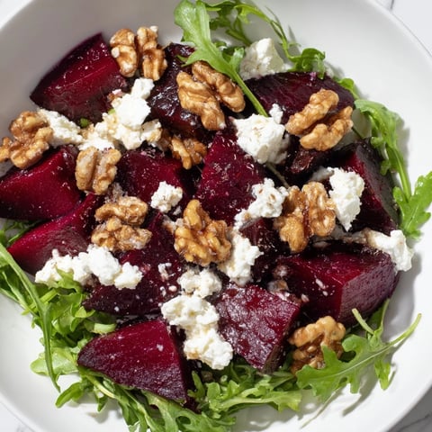 Vibrant photograph of a Roasted Beet Walnut Salad, showcasing roasted beets and candied walnuts.
