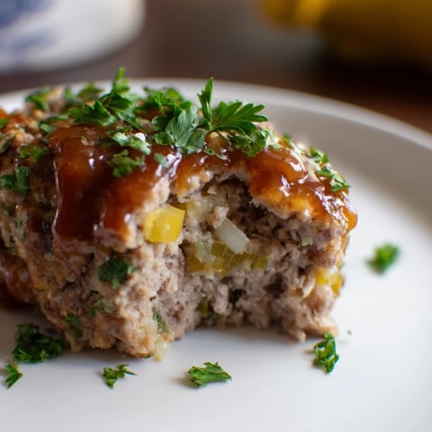 Mini meatloaf bites glistening with maple-mustard glaze, perfect for a cozy weeknight meal.