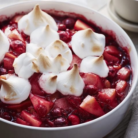 Tantalizing image of Cranberry and Pear Snowscape: baked fruit beneath a billowy, golden meringue.