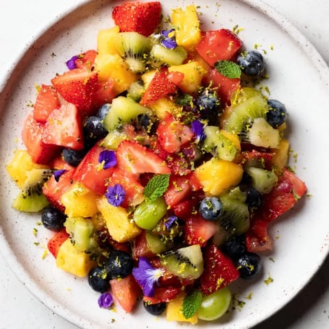 Vibrant image shows the delicious colors of the Festive Bow Fruit Medley with a light, fresh glaze.