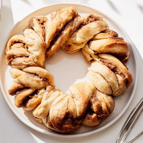 Warm, fresh-baked Cinnamon Roll Pull-Apart Wreath, a delicious brunch treat with sweet cinnamon and glaze.