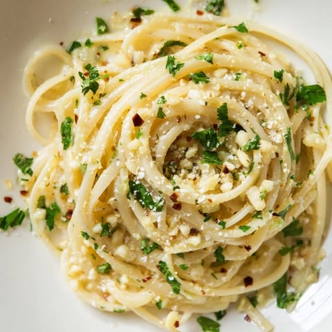 Savory Garlic Butter Linguine, perfectly coated in a rich sauce, garnished with fresh parsley and parmesan.