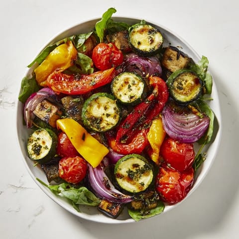Warm, flavorful roasted vegetable salad, featuring perfectly roasted vegetables drizzled with a tangy balsamic glaze.