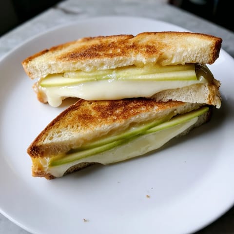 Indulge in this Brie and apple grilled cheese, oozing with creamy cheese and sweet, juicy apples.