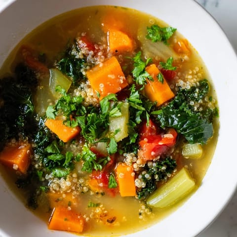 A close-up shot of the Nourishing Winter Veggie Soup, with fresh parsley and a bright aroma filling the air.