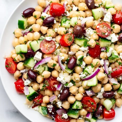 A refreshing bowl of Mediterranean Chickpea Salad with colorful vegetables, perfect for a light lunch.