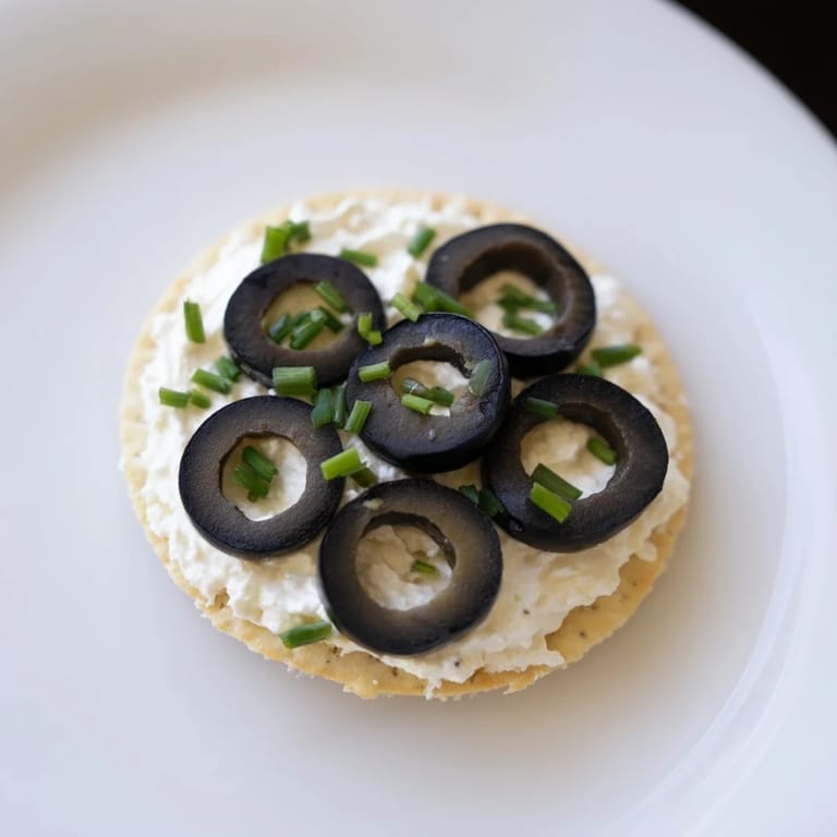 Visually appealing Gold Medal Olympic Ring Appetizers featuring fresh veggies and cream cheese on crackers.