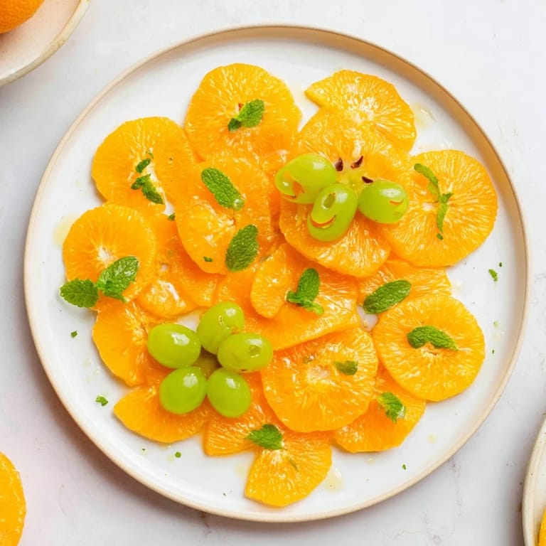 Close-up of bright orange slices decorated like pumpkins, a fun and easy Halloween treat idea.