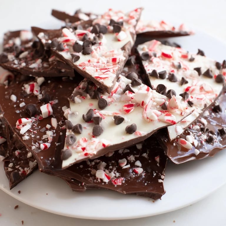 Close-up of freshly broken Peppermint Bark, showcasing layers of dark and white chocolate.
