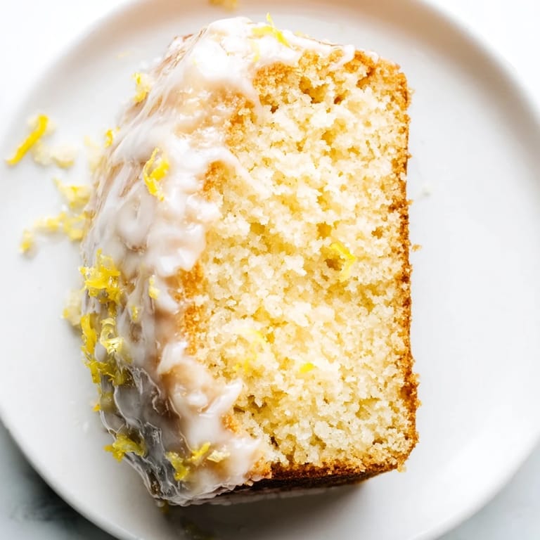 A close-up shot of a golden, tender lemon yogurt cake, ideal for a sweet breakfast or snack.