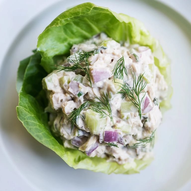 Colorful platter of Dill Pickle Chicken Salad Lettuce Cups topped with fresh dill, crunchy celery, and a creamy dressing for a refreshing meal.