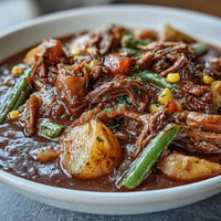 A steaming bowl of Kentucky Derby Burgoo Stew filled with tender beef, pork, and chicken alongside colorful vegetables.