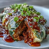 Steamed Korean Cabbage Rolls glistening, filled with spiced beef, ready for dipping.